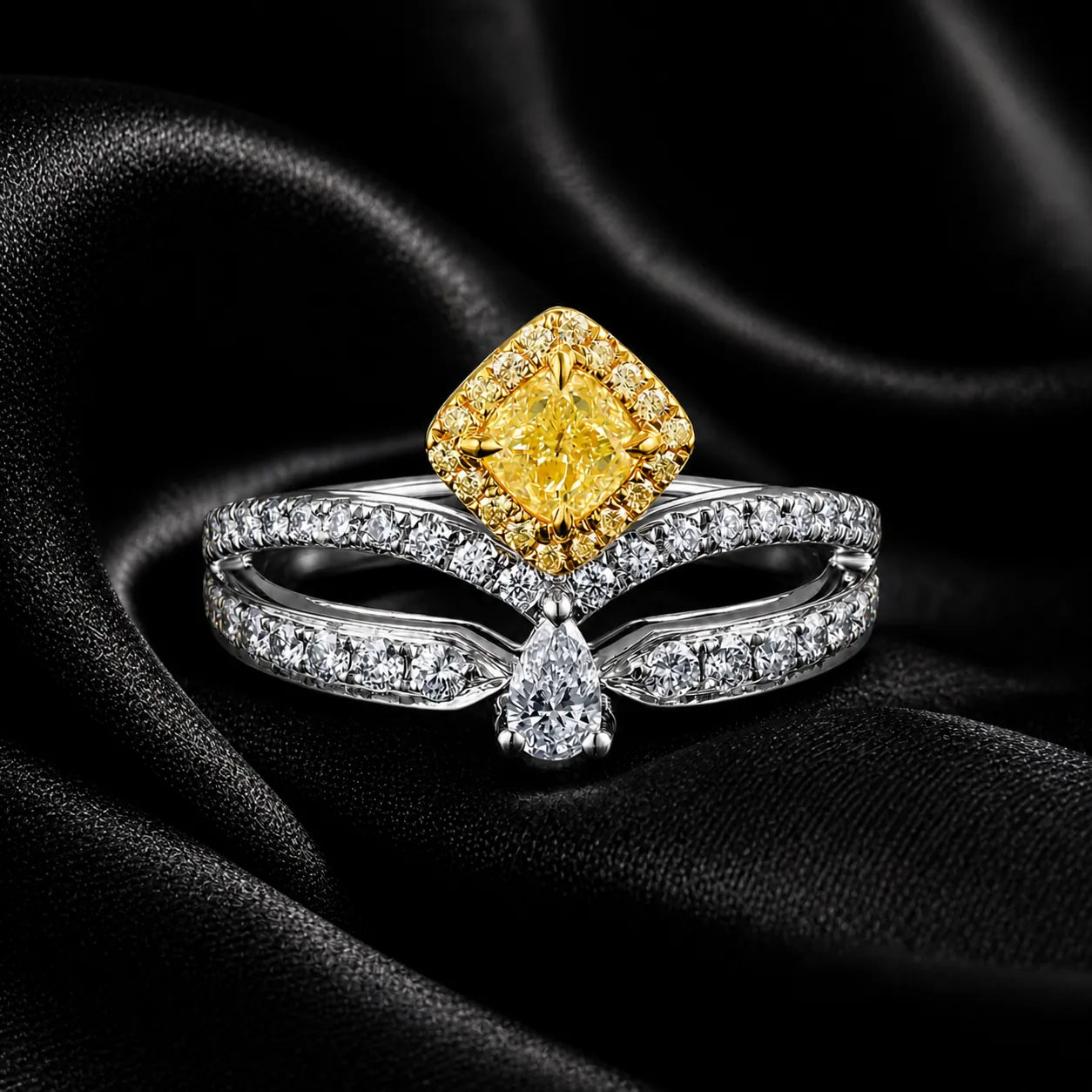 Luxury two-tone diamond ring with yellow halo center stone on black satin fabric