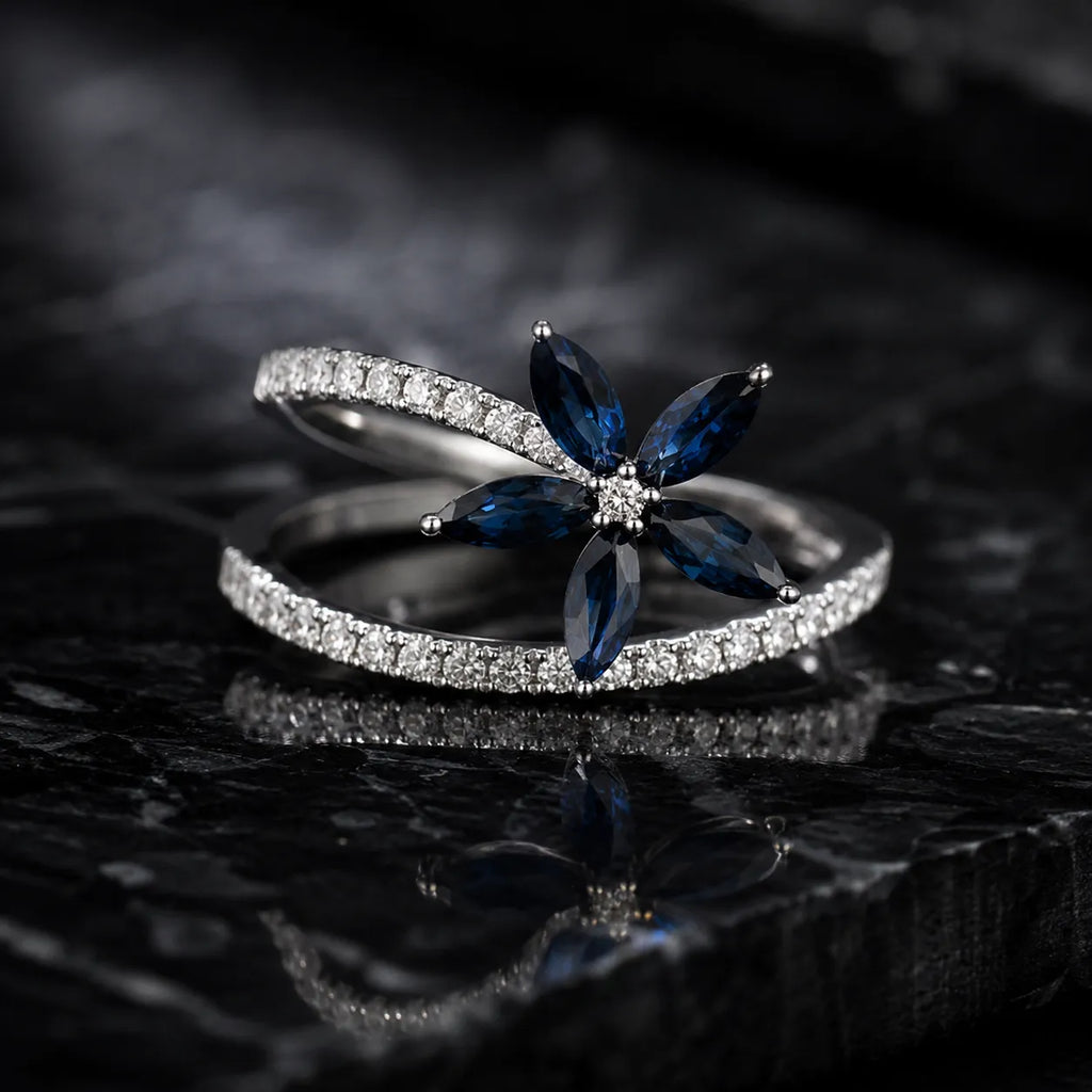 MUHUANG blue sapphire flower ring with diamond accents on black marble background