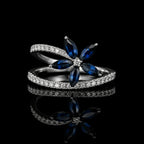 MUHUANG white gold blue sapphire and diamond flower ring on black background
