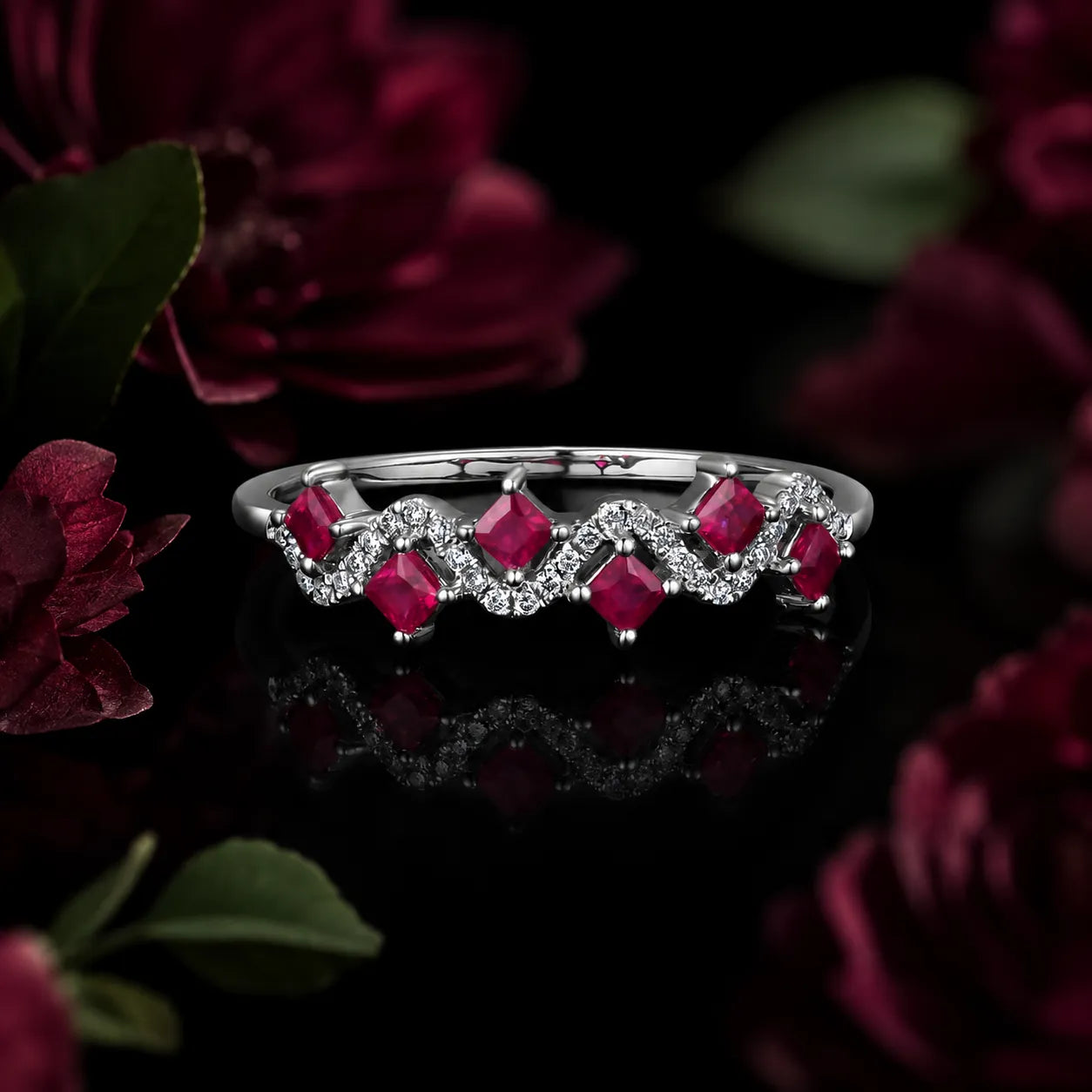 MUHUANG ruby and diamond wave ring in white gold on dark floral background