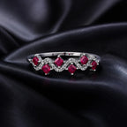 MUHUANG ruby and diamond wave ring displayed on black satin fabric