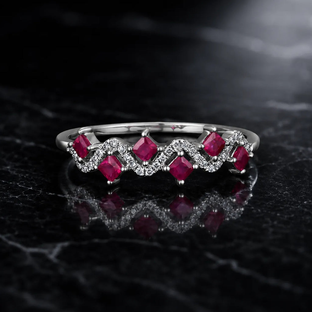 MUHUANG white gold ruby ring with diamond wave design on black marble background