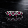 MUHUANG white gold ruby ring with diamond wave design on black marble background