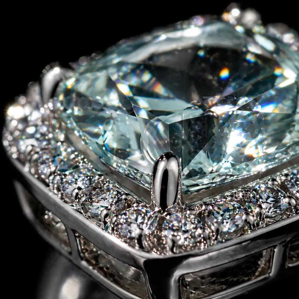 MUHUANG cushion-cut light blue gemstone stud earring with diamond halo, close-up showing exquisite facets and luxury craftsmanship.