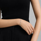 Minimalist diamond bracelet worn on wrist, styled with black outfit, showing elegant fit