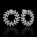 MUHUANG white gold diamond laurel leaf hoop earrings on black background