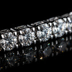 Close-up of MUHUANG diamond bracelet, featuring round brilliant-cut diamonds set in white gold, reflecting light on black background