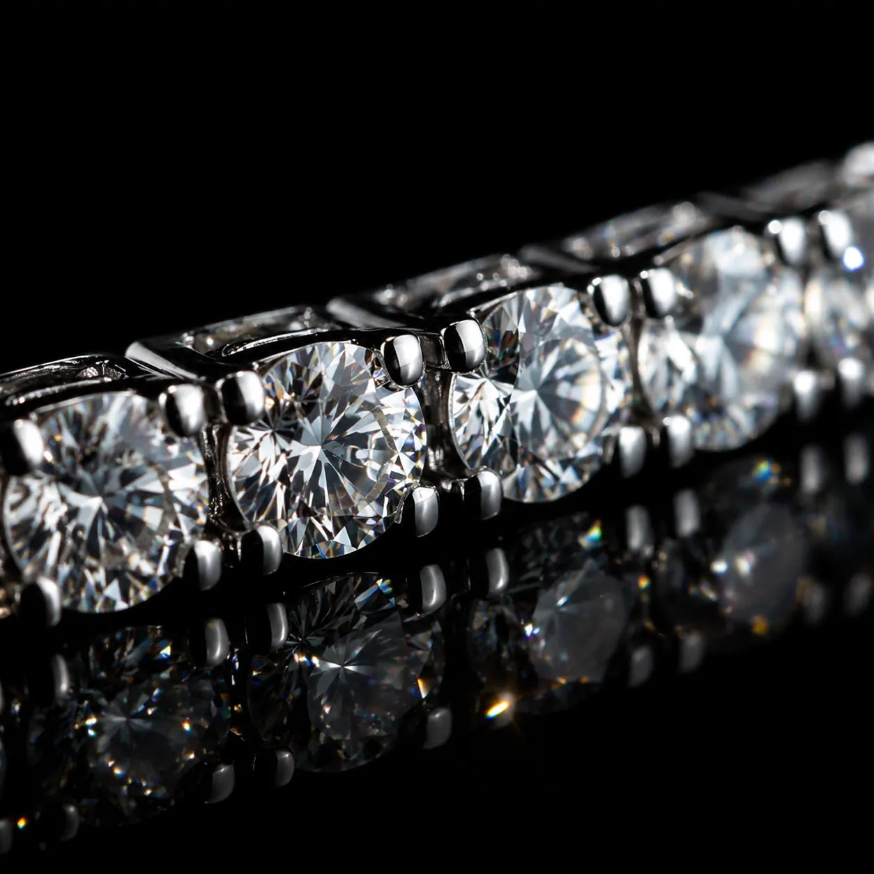 Close-up of MUHUANG diamond bracelet, featuring round brilliant-cut diamonds set in white gold, reflecting light on black background