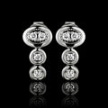 MUHUANG white gold diamond drop earrings on black background