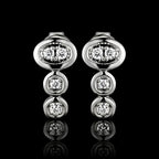 MUHUANG white gold diamond drop earrings on black background