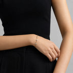 Close-up of MUHUANG rose-gold bracelet with three bezel-set diamonds, highlighting craftsmanship and minimalist design.
