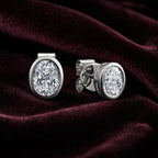 MUHUANG white gold oval diamond stud earrings on burgundy velvet