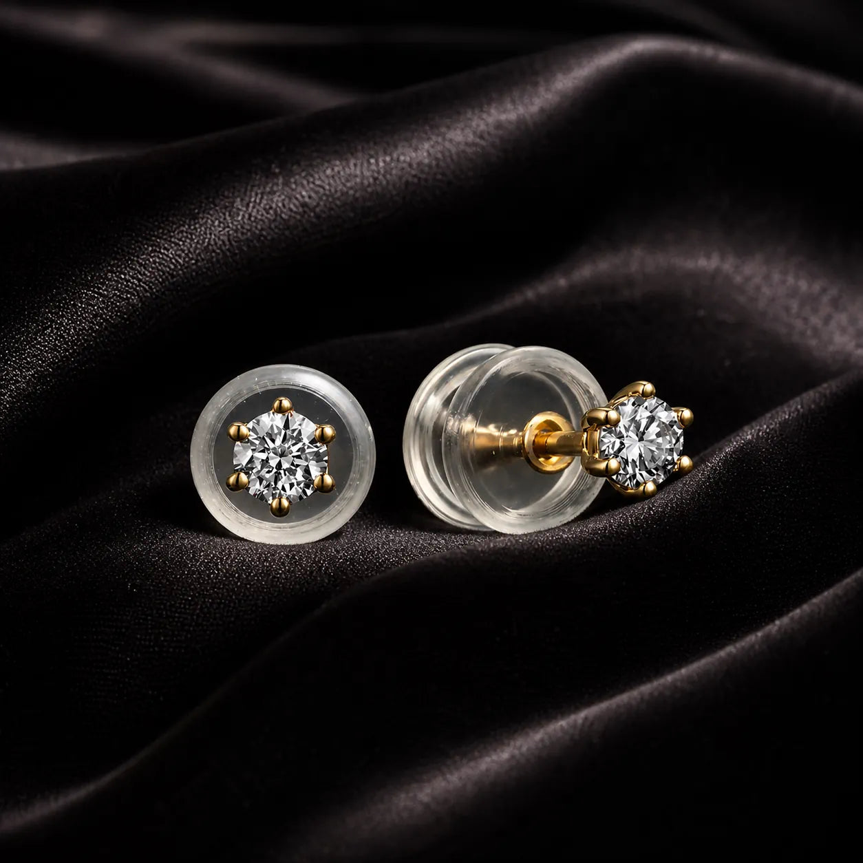 MUHUANG yellow gold diamond stud earrings on black satin fabric