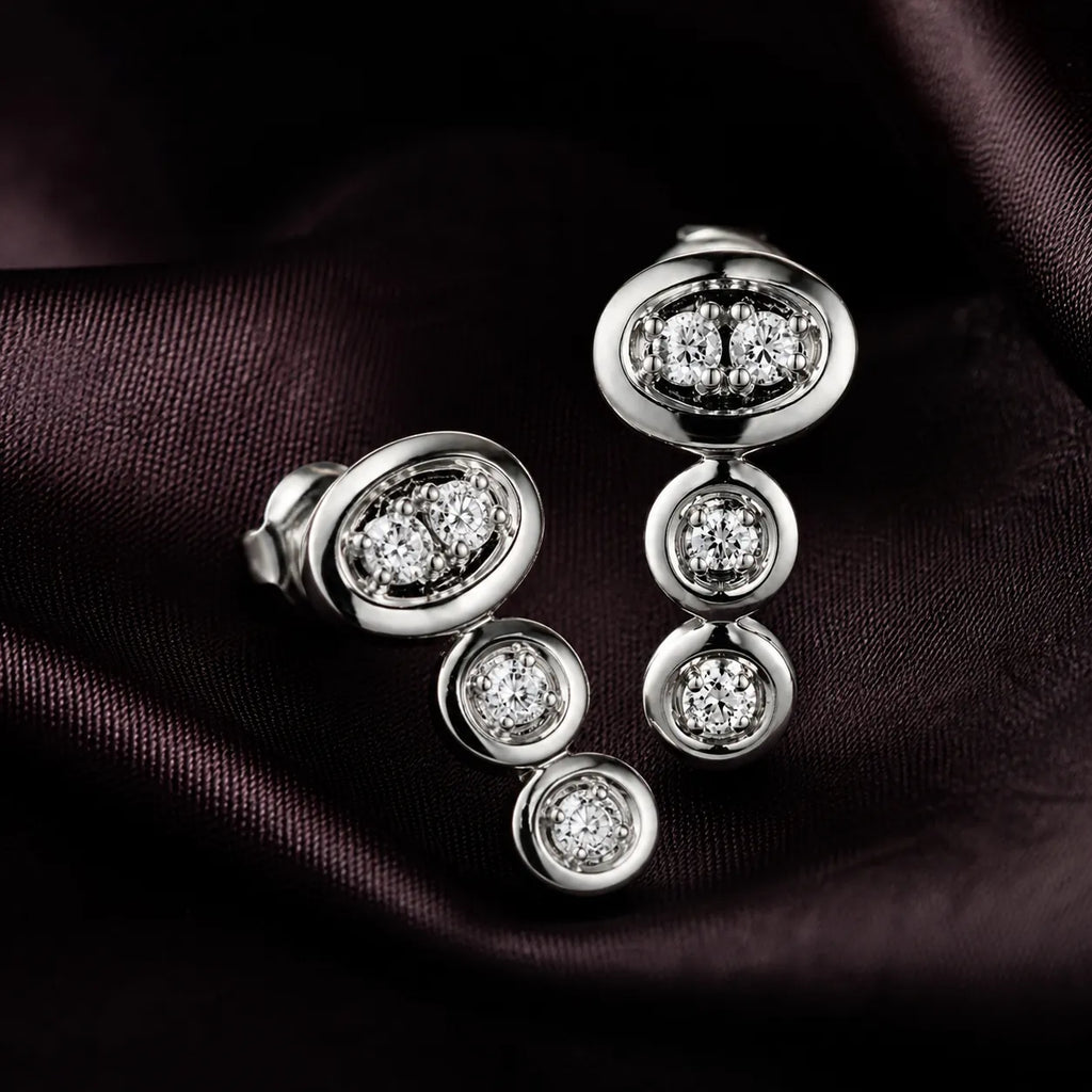 MUHUANG diamond drop earrings on dark satin fabric