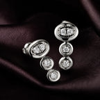MUHUANG diamond drop earrings on dark satin fabric