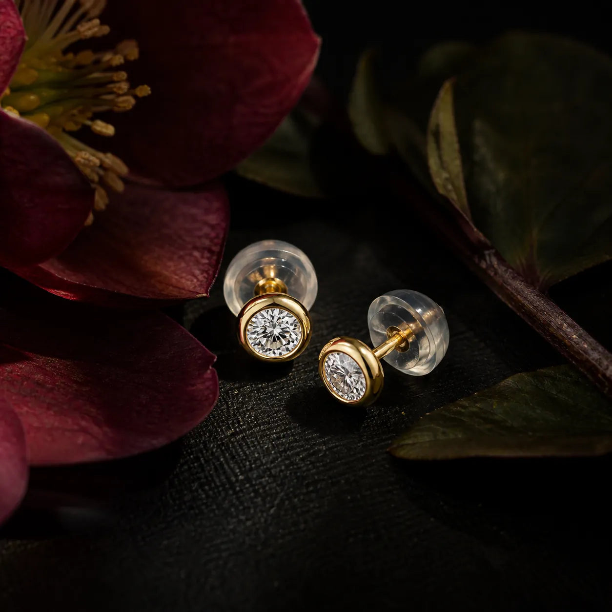 MUHUANG yellow gold diamond stud earrings styled with red flower and dark leaves