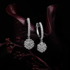 MUHUANG white gold diamond drop hoop earrings with dark floral background