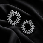 MUHUANG diamond laurel leaf hoop earrings on black satin fabric