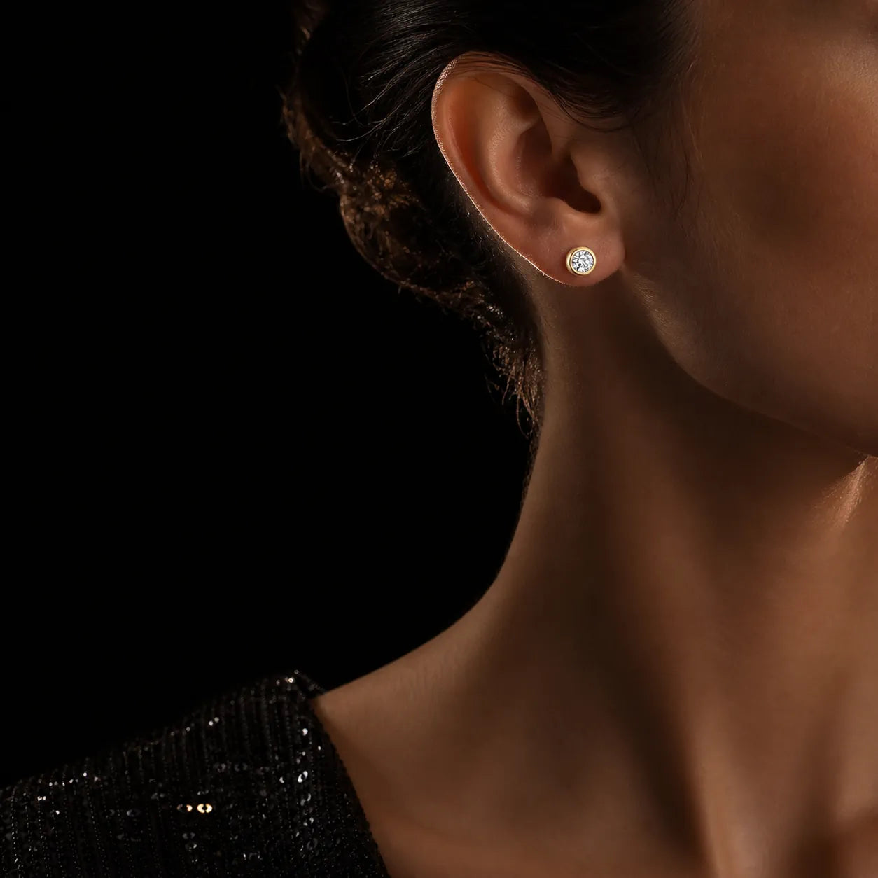MUHUANG yellow gold diamond stud earring worn with black evening dress