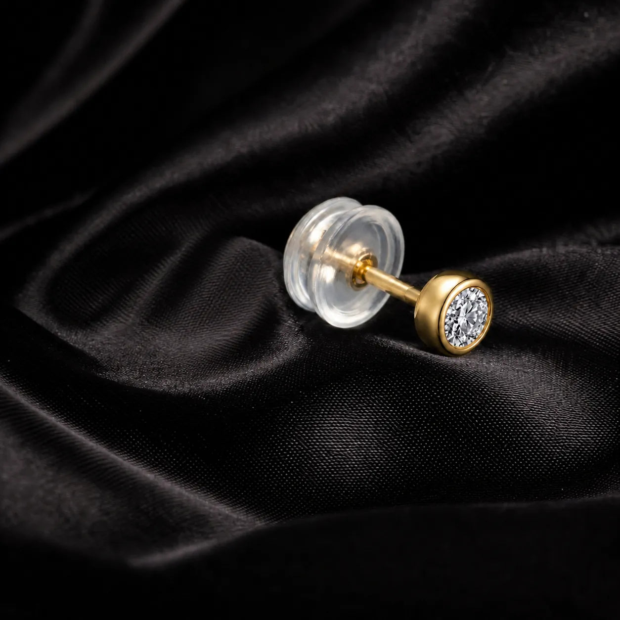 MUHUANG yellow gold diamond stud earring on black satin fabric