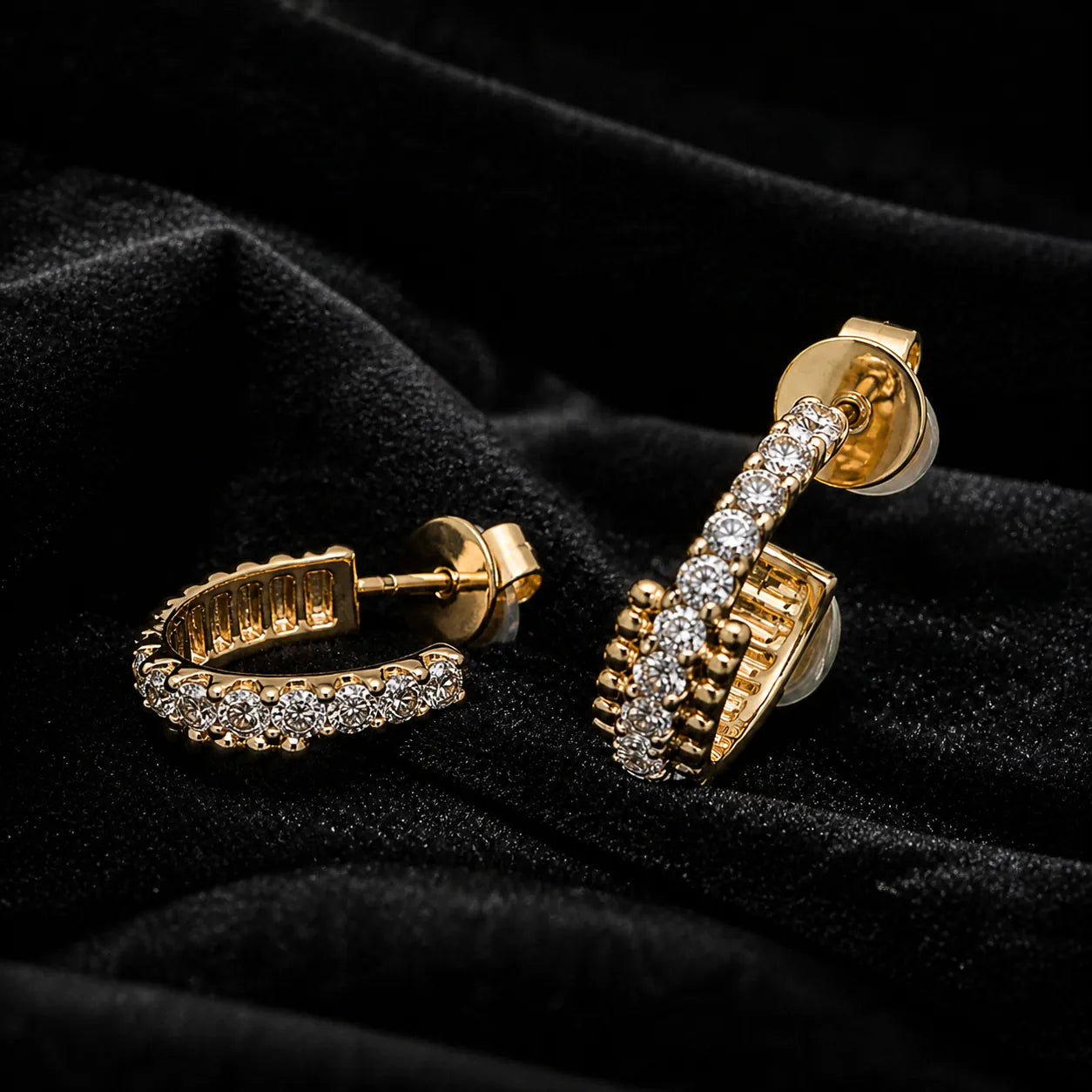 MUHUANG yellow gold diamond hoop earrings on black velvet