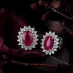 MUHUANG ruby and diamond halo stud earrings with dark floral background