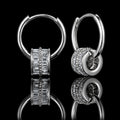 MUHUANG white gold baguette diamond charm hoop earrings on black reflective background