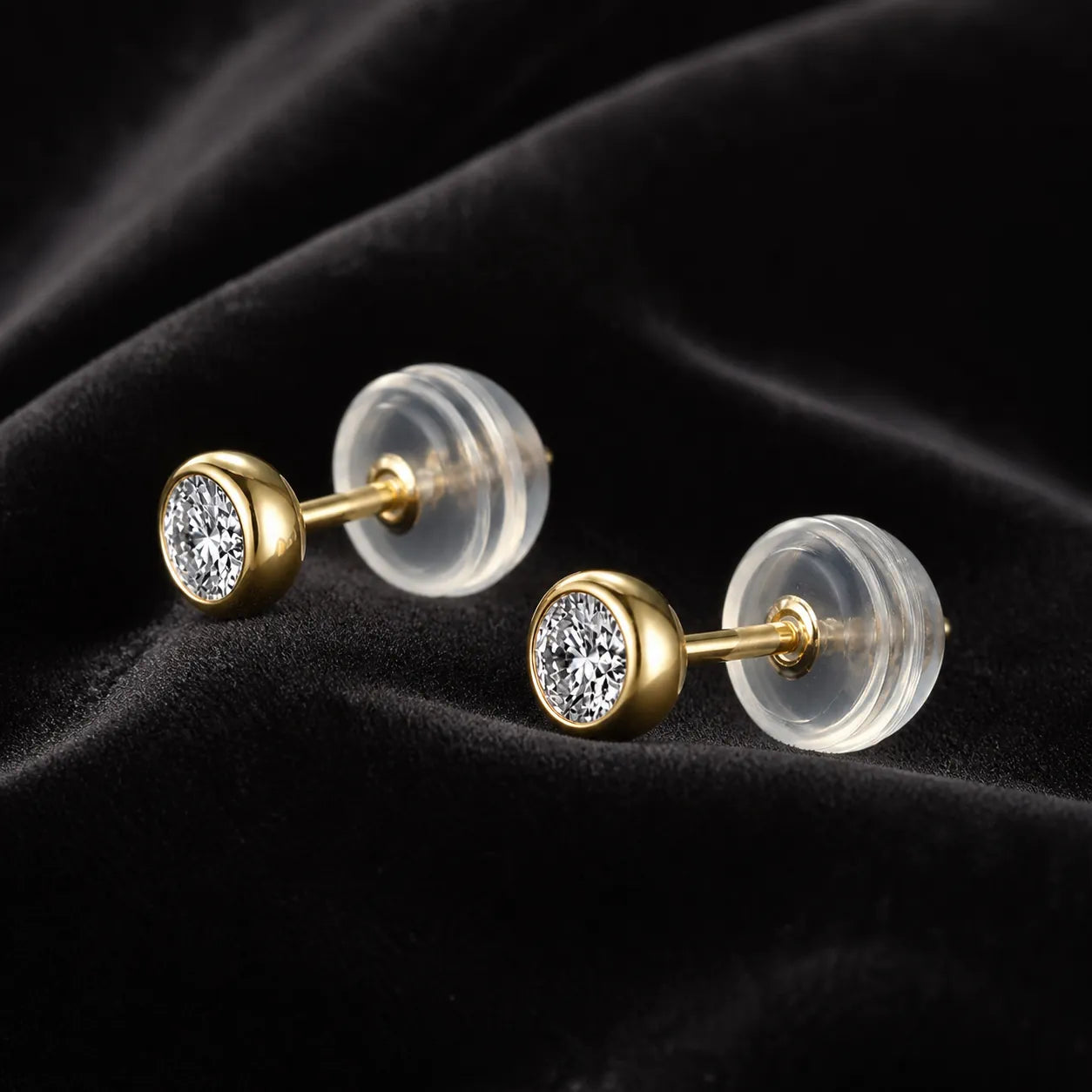 MUHUANG yellow gold diamond stud earrings on black velvet backdrop