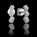 MUHUANG 18K white gold oval diamond drop earrings on black reflective background