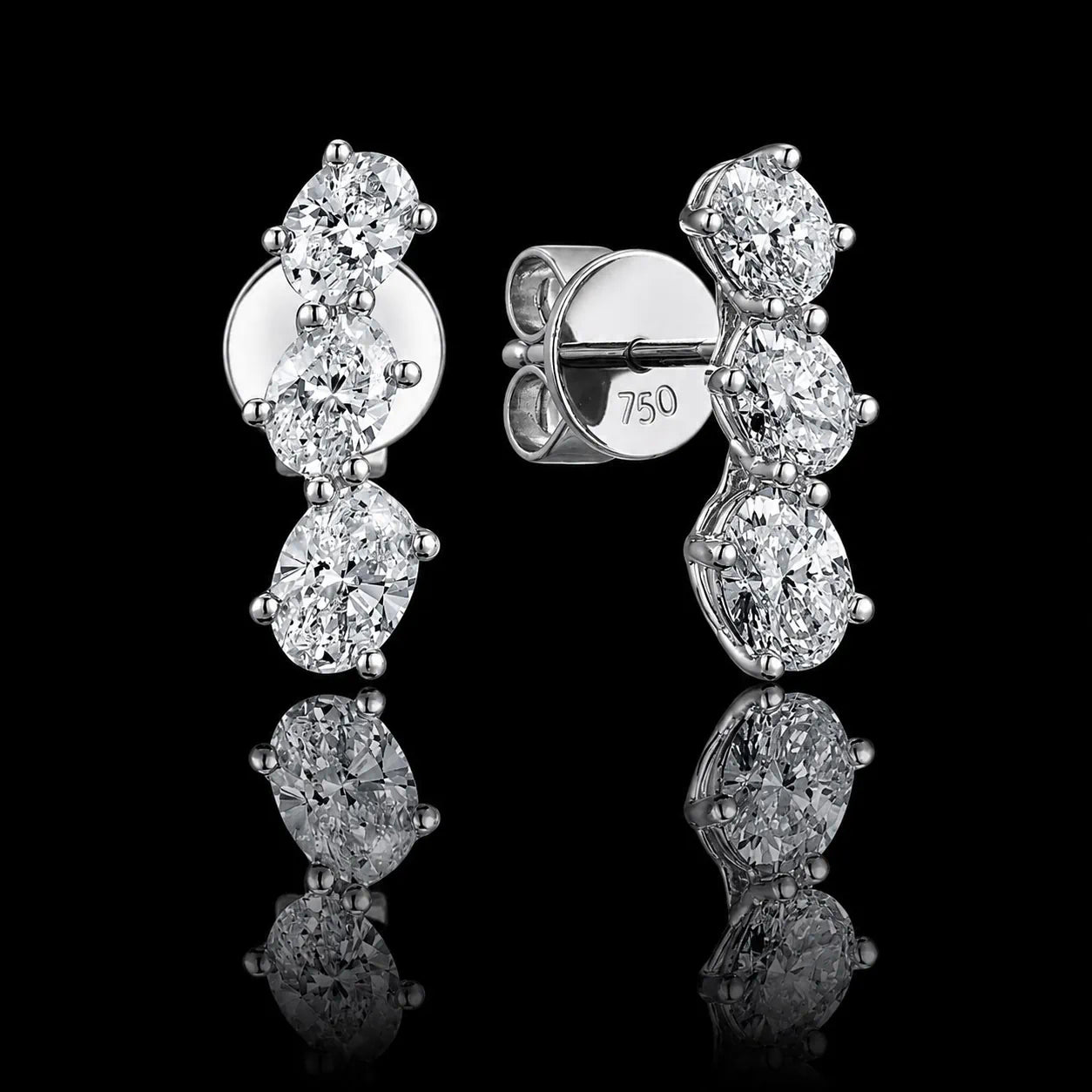 MUHUANG 18K white gold oval diamond drop earrings on black reflective background