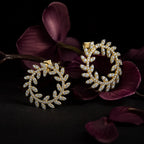 MUHUANG yellow gold diamond leaf hoop earrings with orchid backdrop