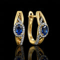 MUHUANG yellow gold blue sapphire diamond hoop earrings on black background
