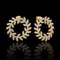 MUHUANG yellow gold diamond laurel hoop earrings on black background