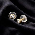 MUHUANG yellow gold diamond stud earrings on black velvet