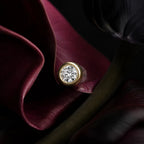 MUHUANG yellow gold diamond stud earring on dark burgundy petals