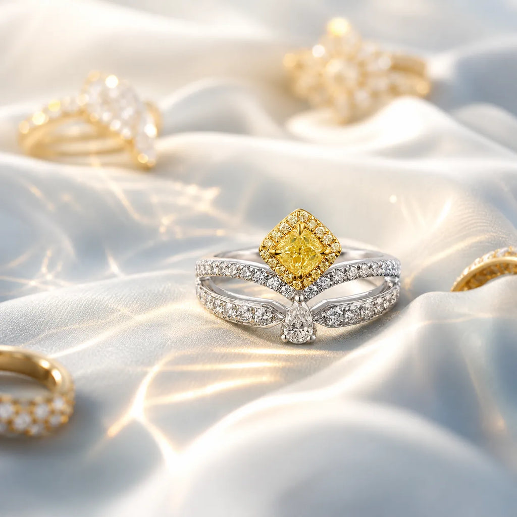 18K yellow and white gold yellow diamond ring displayed on white satin fabric with soft reflections, showcasing halo and side diamonds