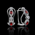 MUHUANG ruby diamond drop earrings on black background