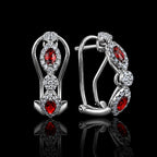 MUHUANG ruby diamond drop earrings on black background