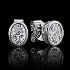 MUHUANG white gold oval diamond stud earrings on black background