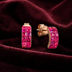 MUHUANG rose gold pink sapphire hoop earrings displayed on burgundy velvet