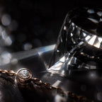 MUHUANG rose-gold bracelet with diamonds placed among crystal reflections on black surface, emphasizing luxury and sparkle.