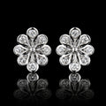 MUHUANG white gold floral diamond stud earrings on black background