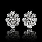 MUHUANG white gold floral diamond stud earrings on black background