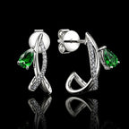 MUHUANG white gold green gemstone drop earrings on black background