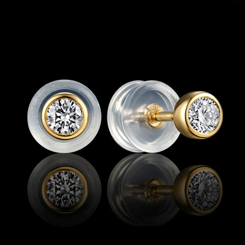 MUHUANG yellow gold diamond stud earrings with silicone backs on black background