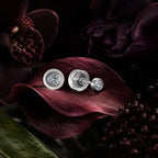 MUHUANG diamond stud earrings displayed on dark burgundy petals