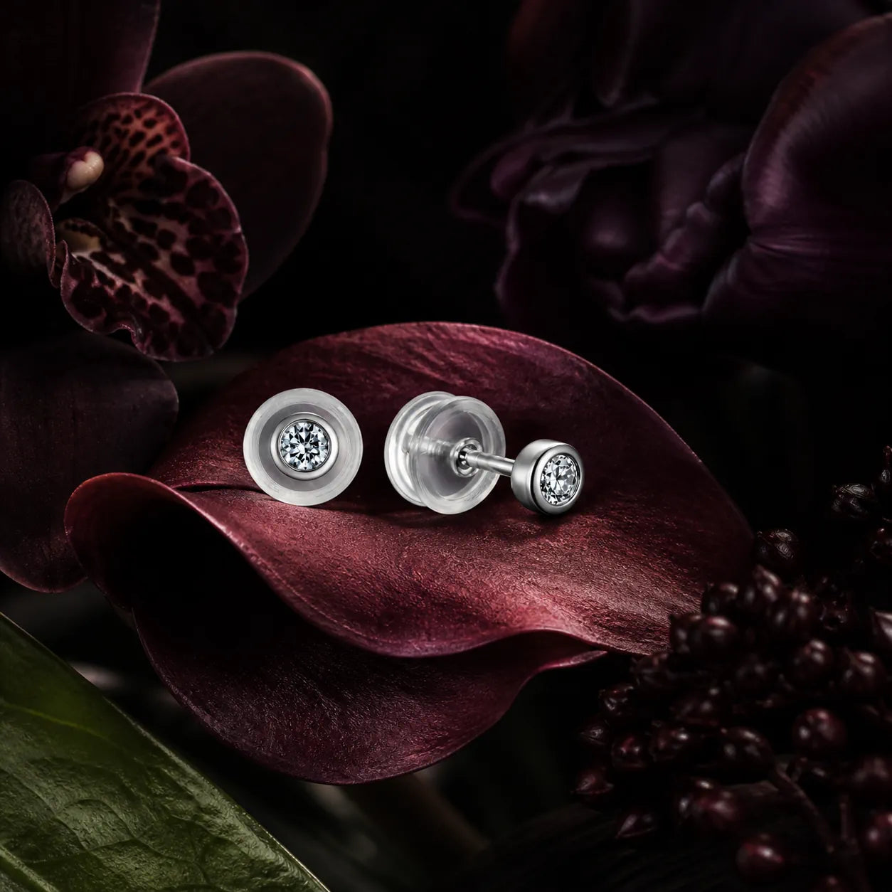 MUHUANG diamond stud earrings displayed on dark burgundy petals