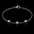 18K white gold delicate bracelet with three round bezel-set diamonds on black background