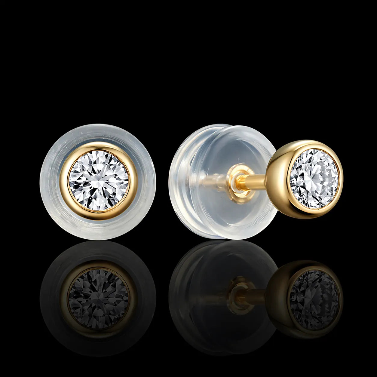 MUHUANG yellow gold diamond stud earrings with silicone backs on black background